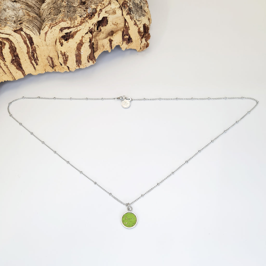 bright green eco cork pendant on a stainless steel chain